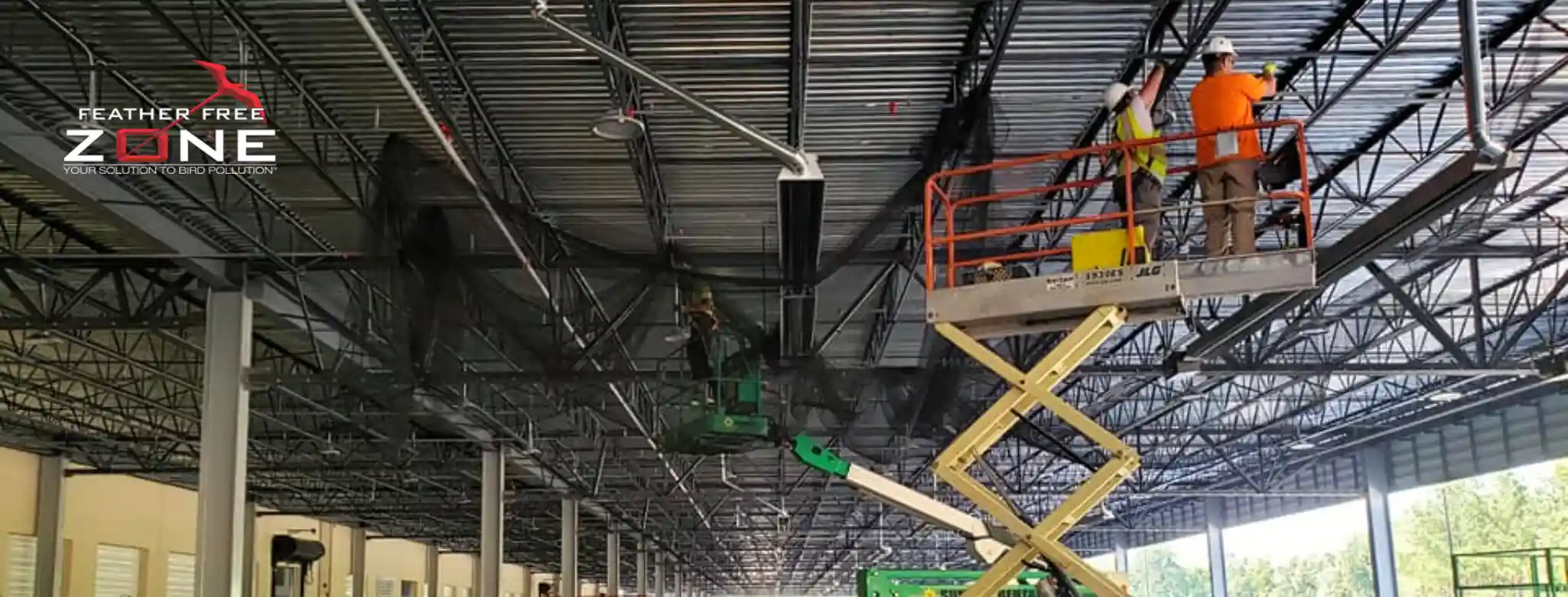 Pest Technicians installing bird nettings on a commercial building