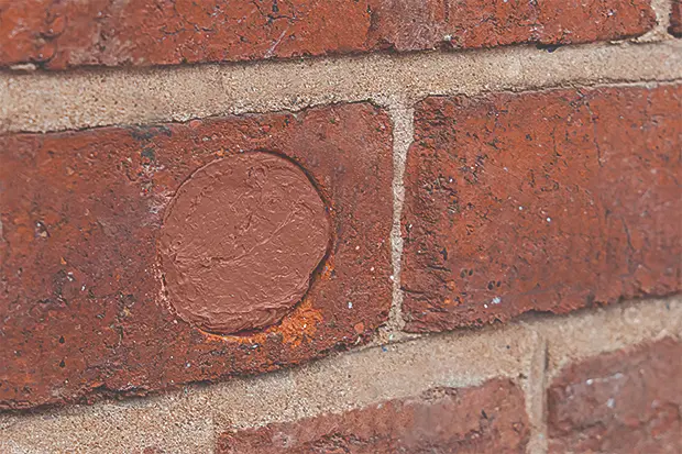 Flexi armour sealant applied to a hole in a brick wall