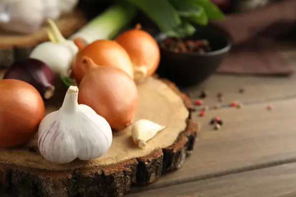 Onions and garlic spread out on a table
