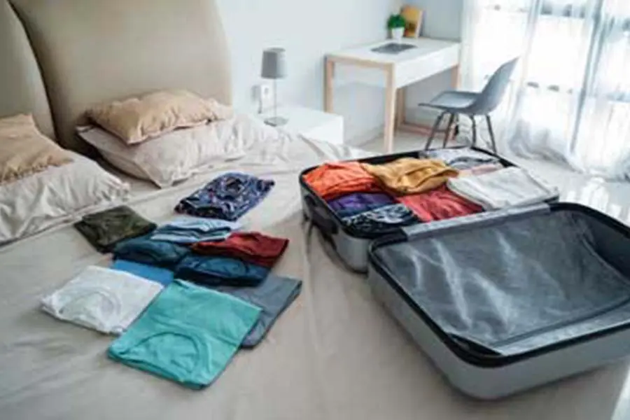 Unpacked luggage on a bed