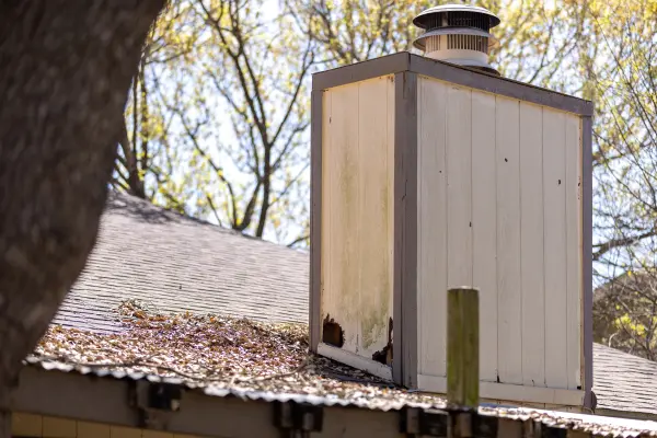 A home's chimney with several holes caused by rodents.